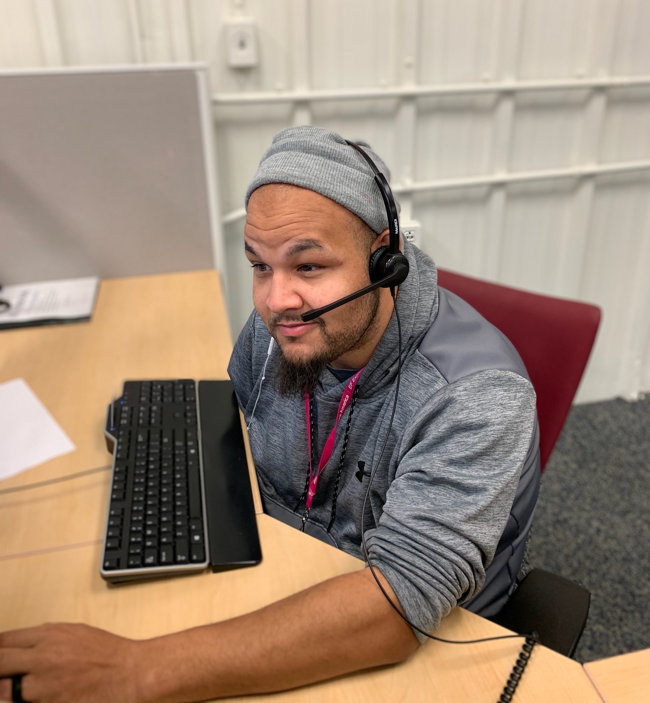 Person sitting at desk with headset