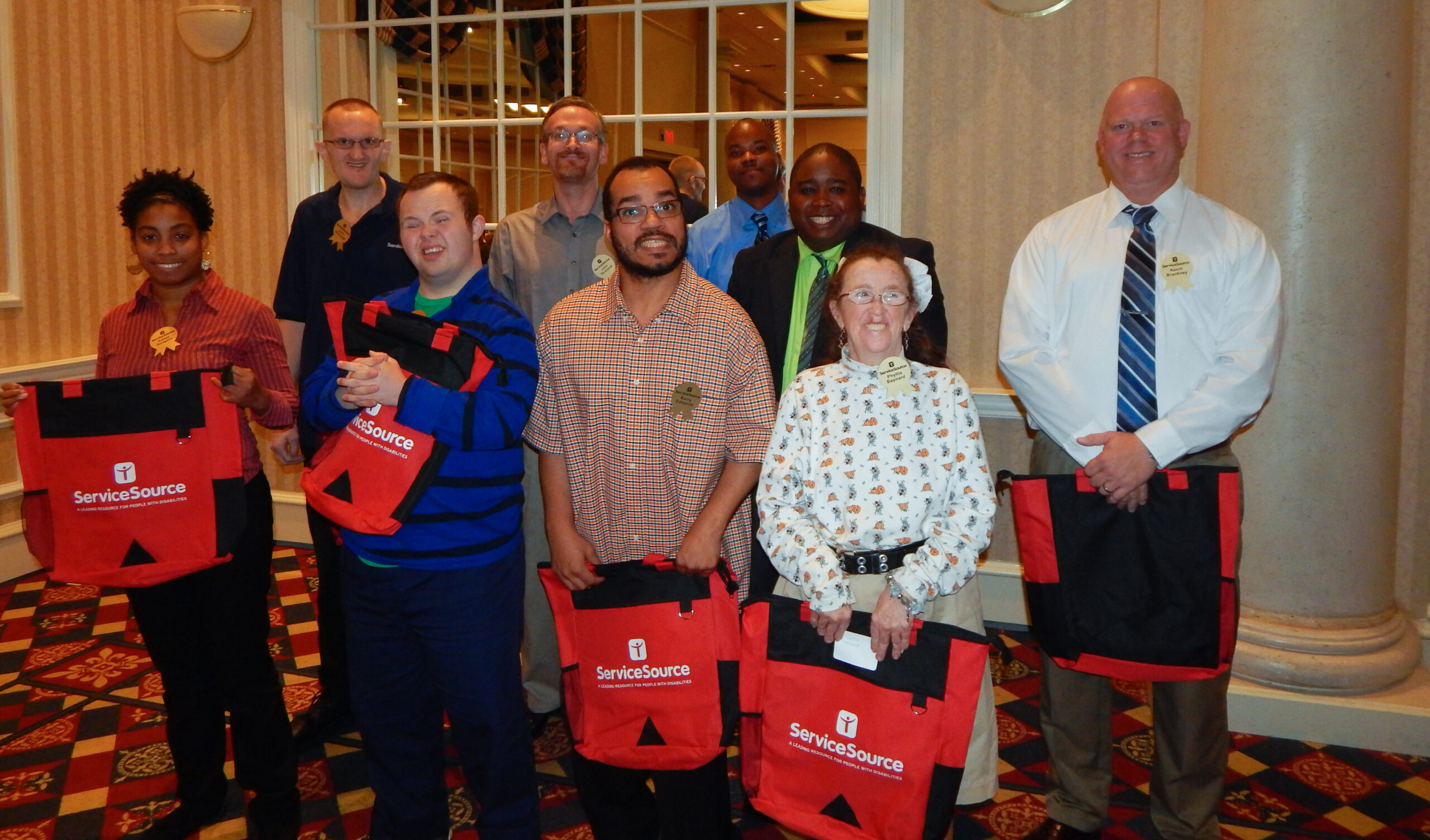 group of people in hotel ballroom smiling at camera