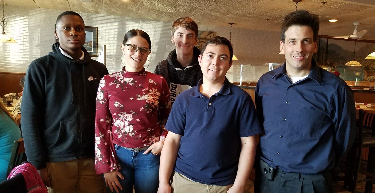 group smiling at camera in restaurant