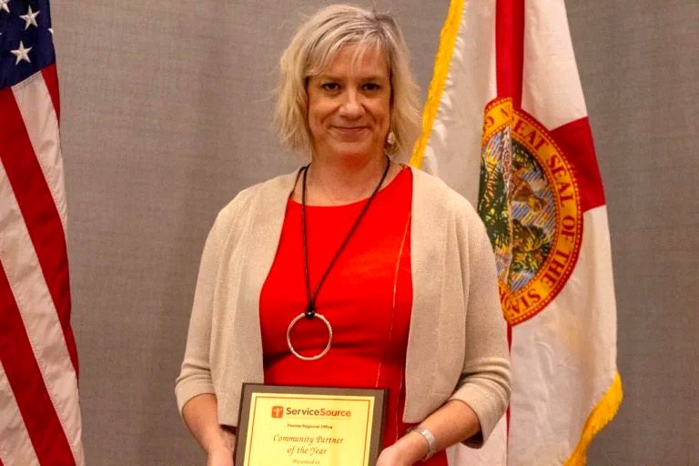 Woman receiving Service Excellence Award in Florida