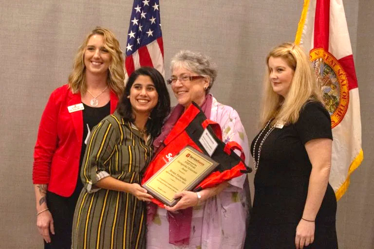 Woman receiving Service Excellence Award in Florida