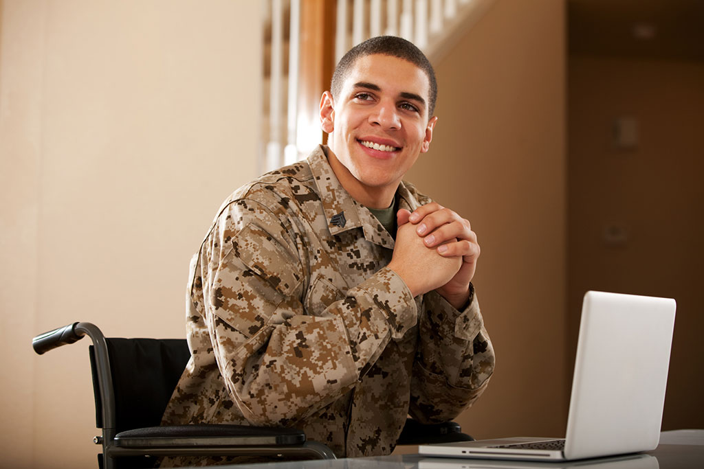 Military Veteran working at a desk on computer