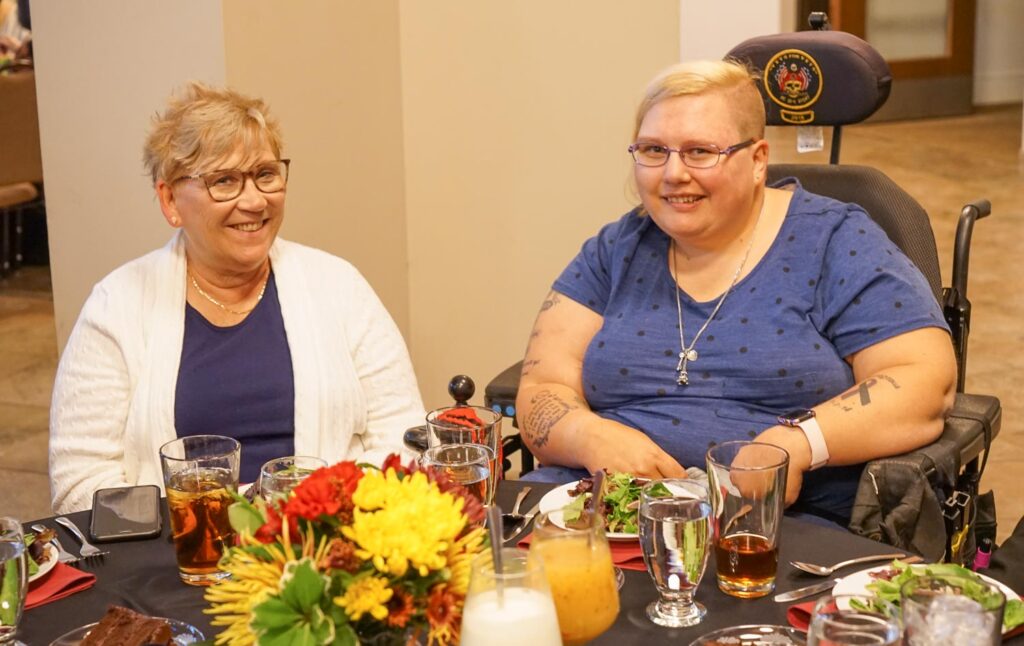 two people sitting at banquet table