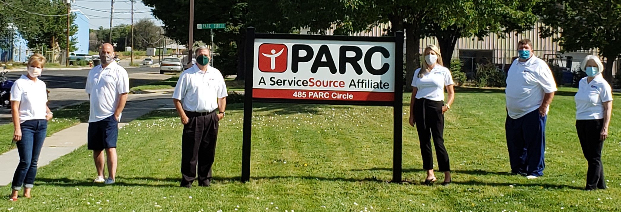 Group of people standing outside in front of sign that says PARC ServiceSource affiliate