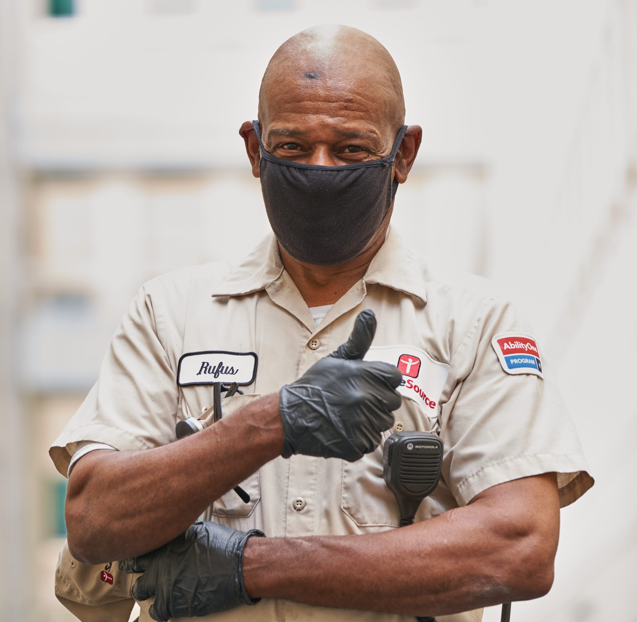 man with mask holding thumbs up