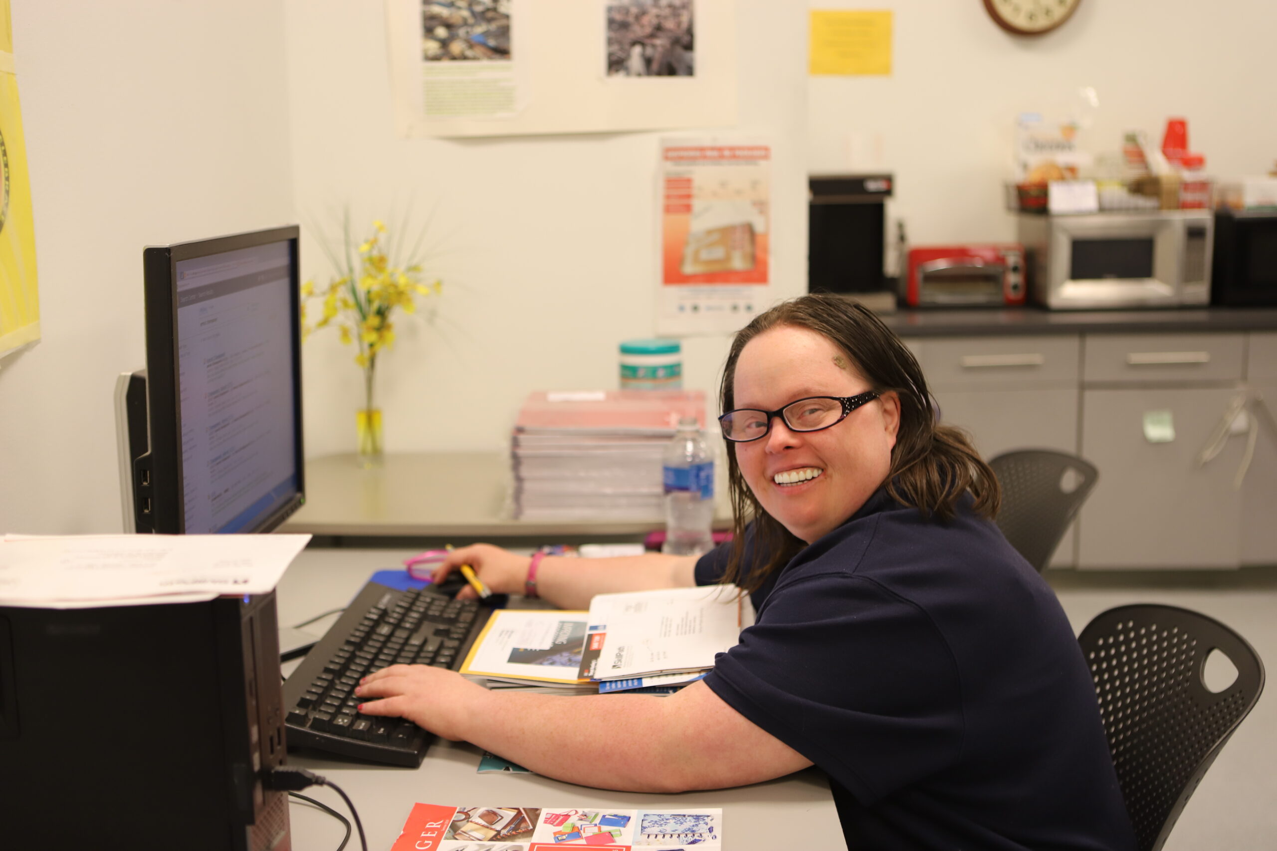 woman at desk typing on computer