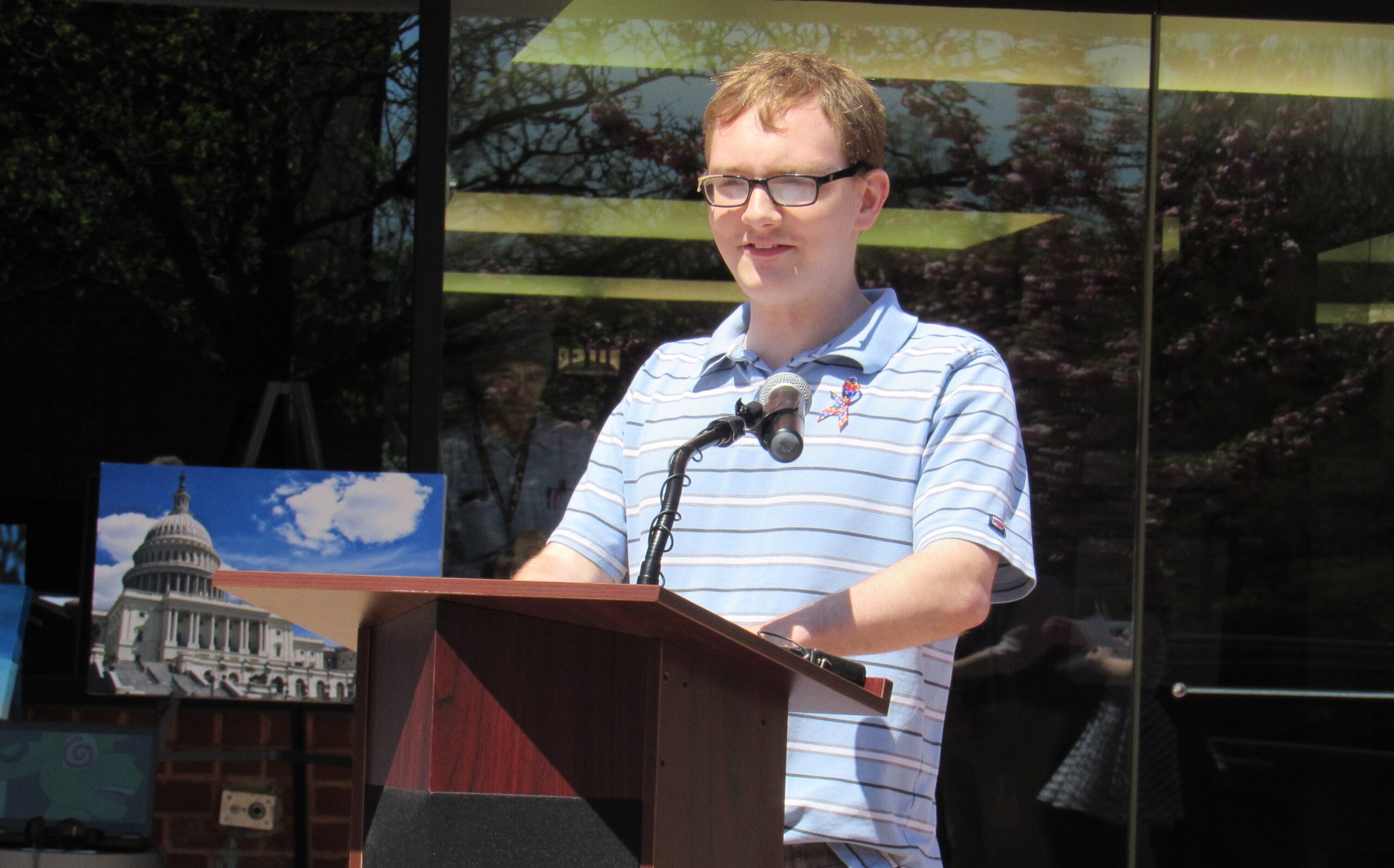 Man at podium speaking into microphone