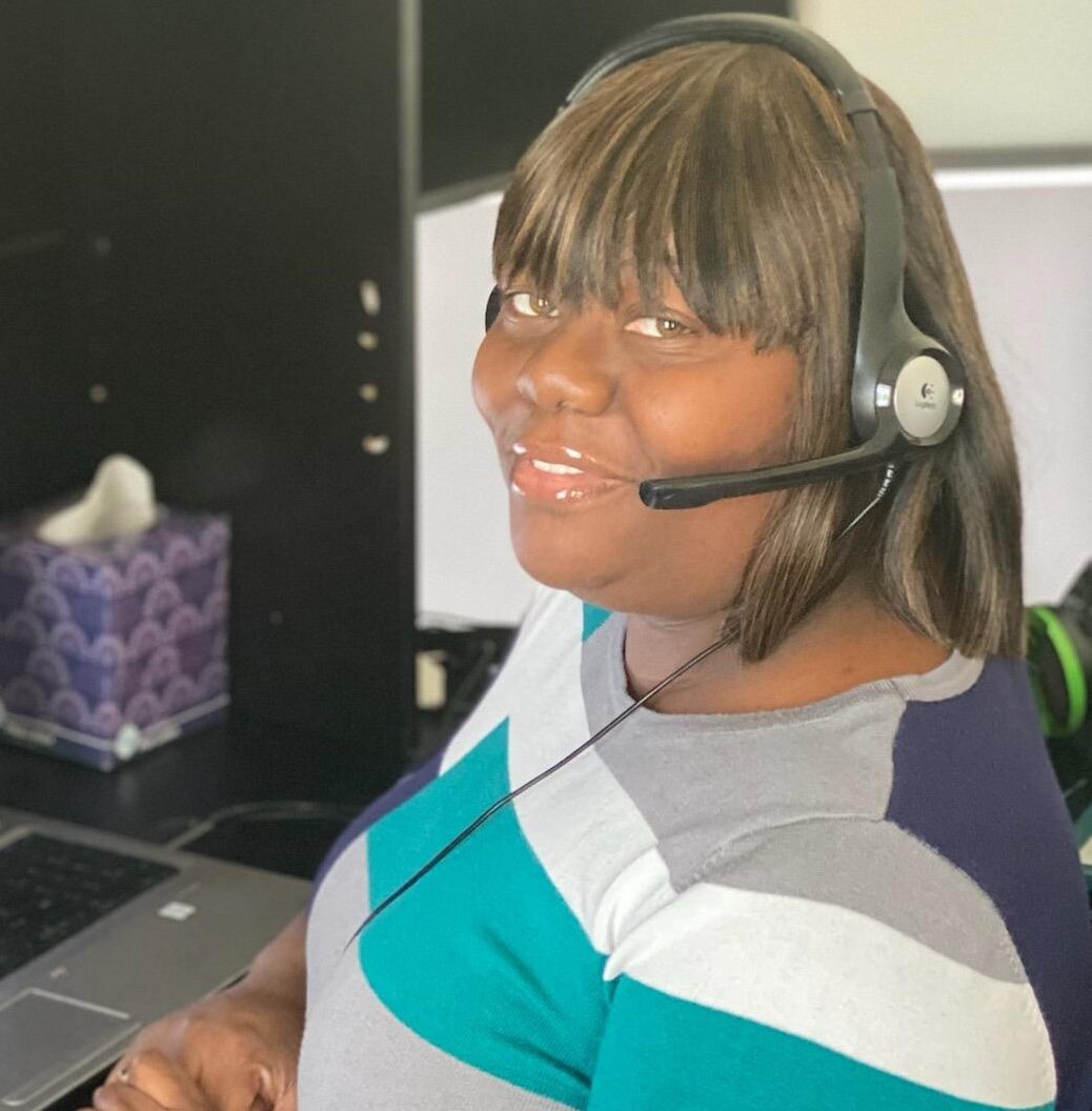 woman with headset smiling at camera