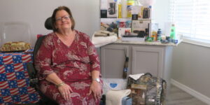 person sitting in wheelchair in front of home essentials