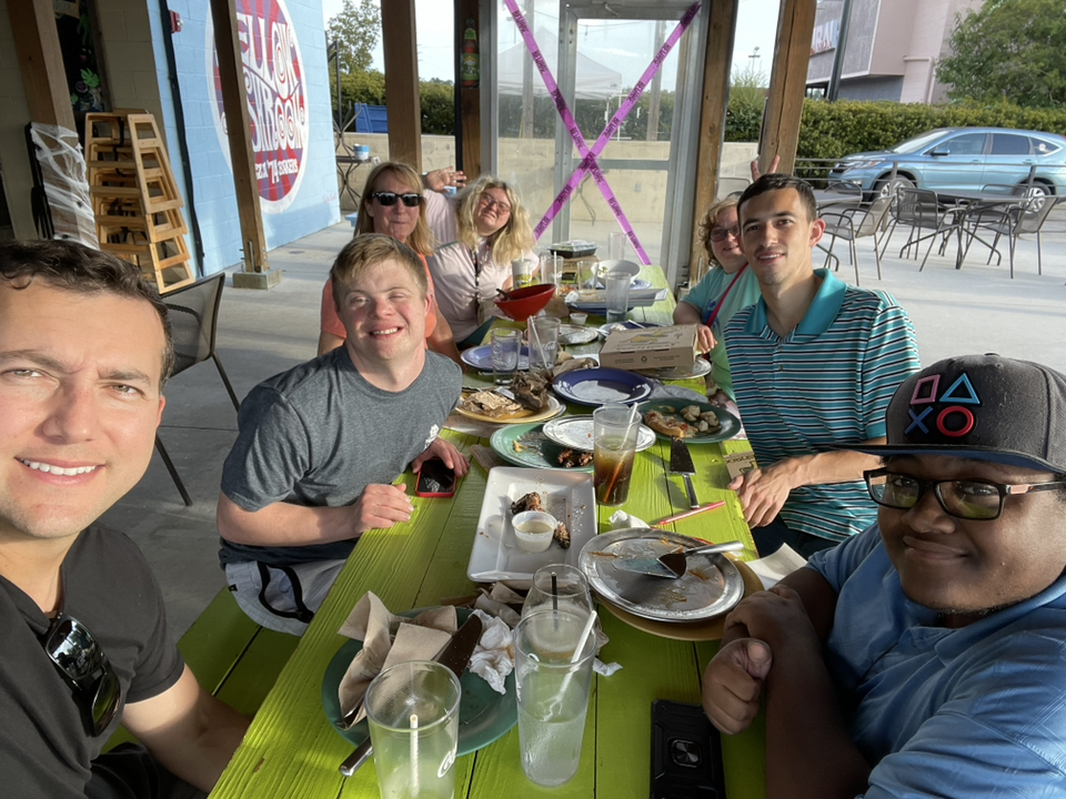 group of people outside at picnic table