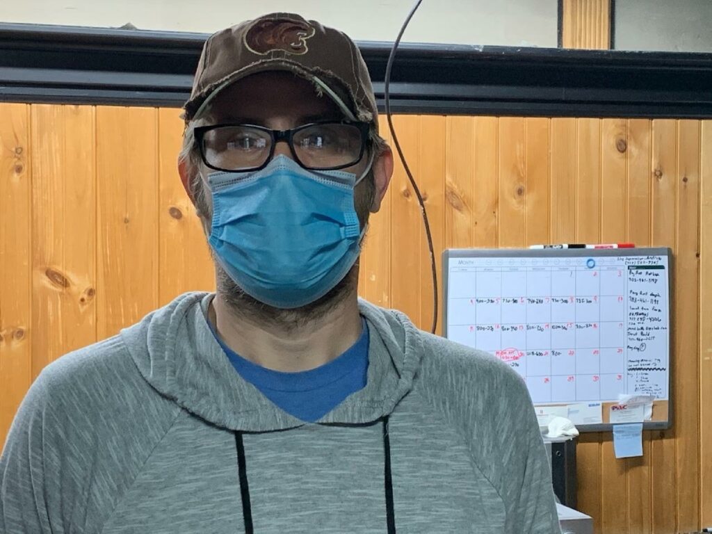 man in blue mask looking at camera