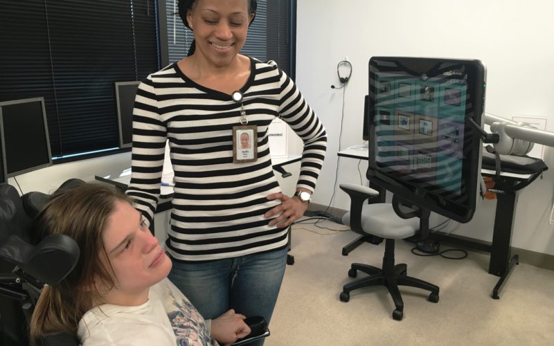 Person is introduced to assistive technology in office setting