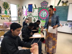 Person standing teaching students at desks