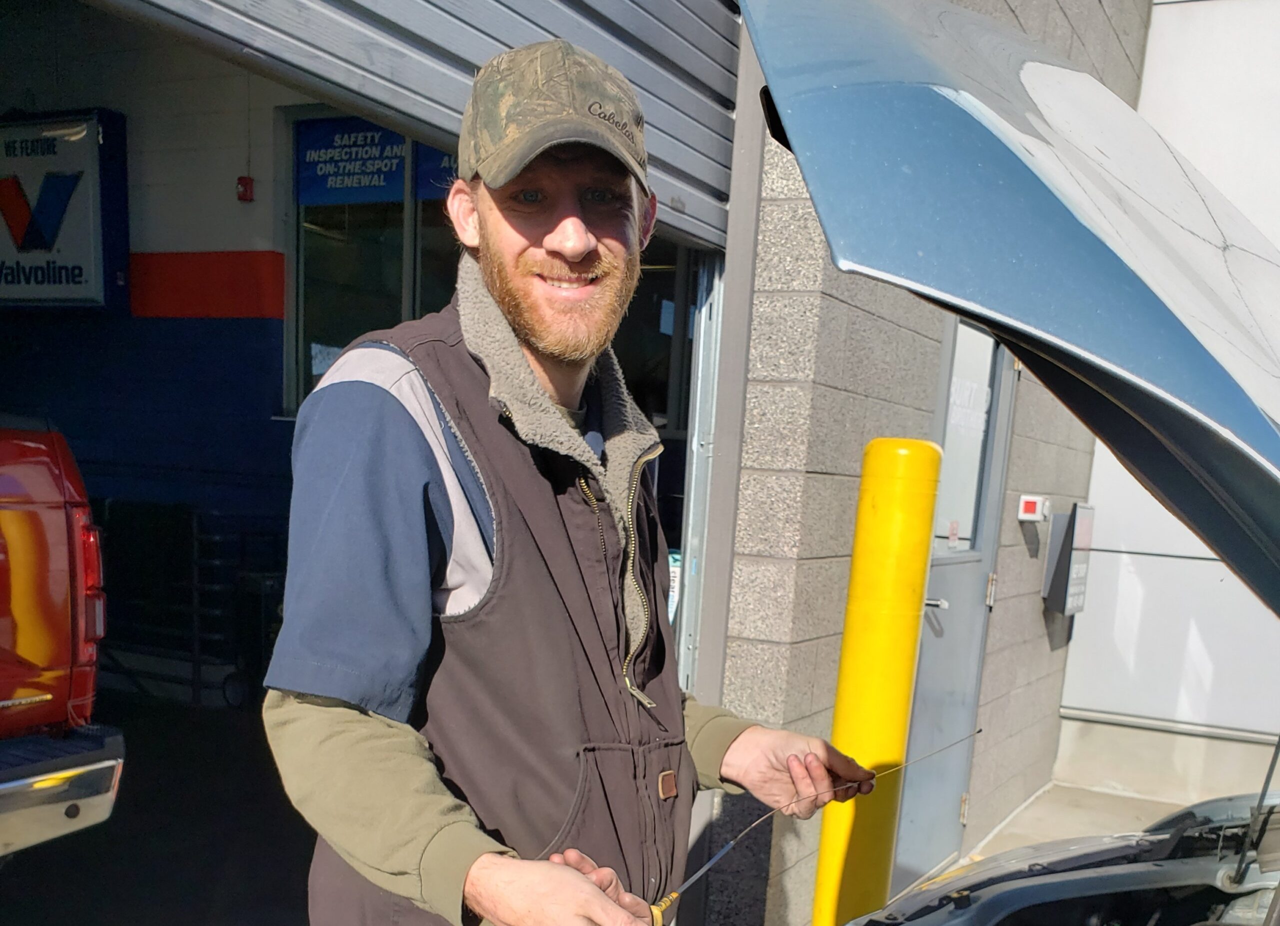 Person outside working on car