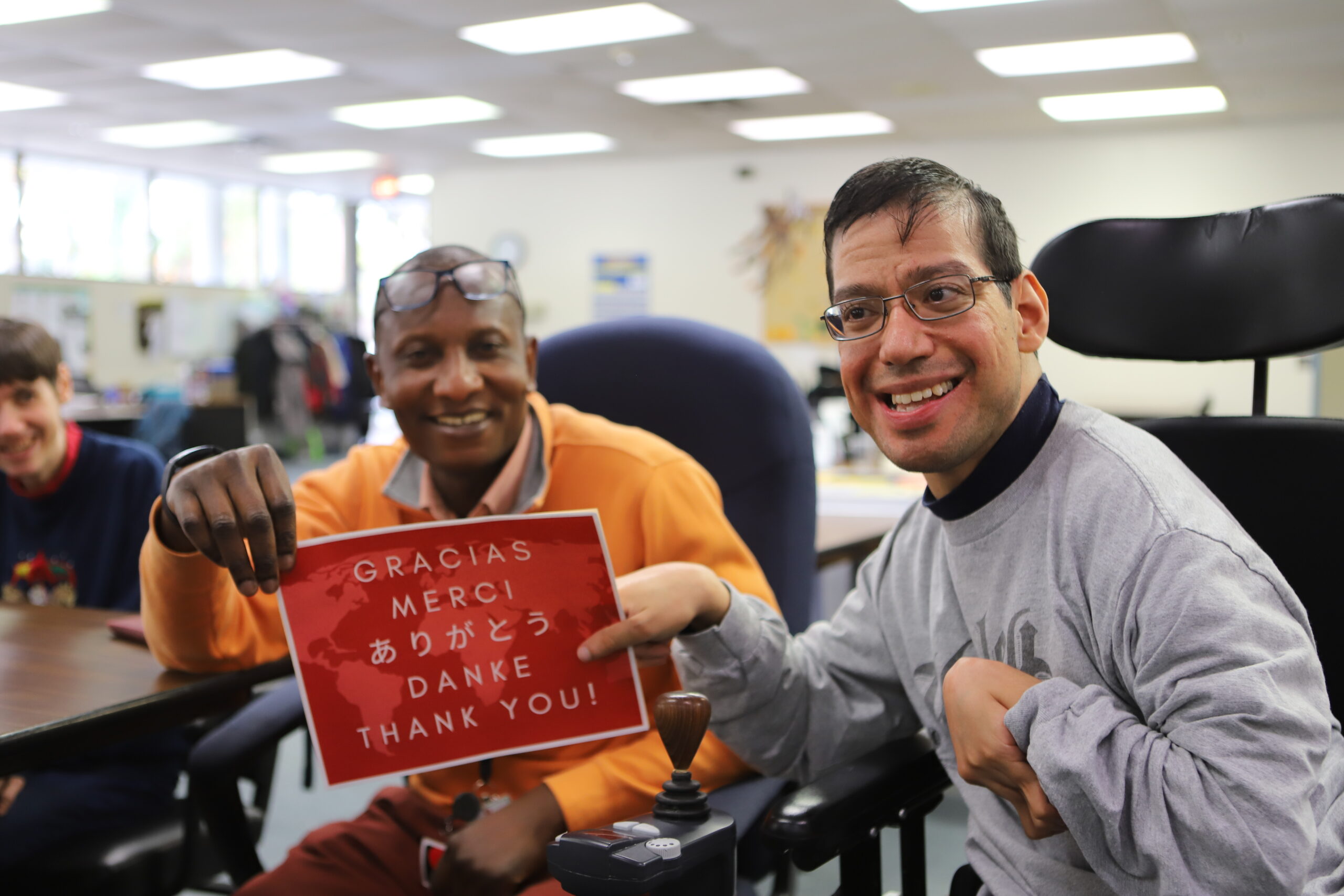 two people holding one thank you sign