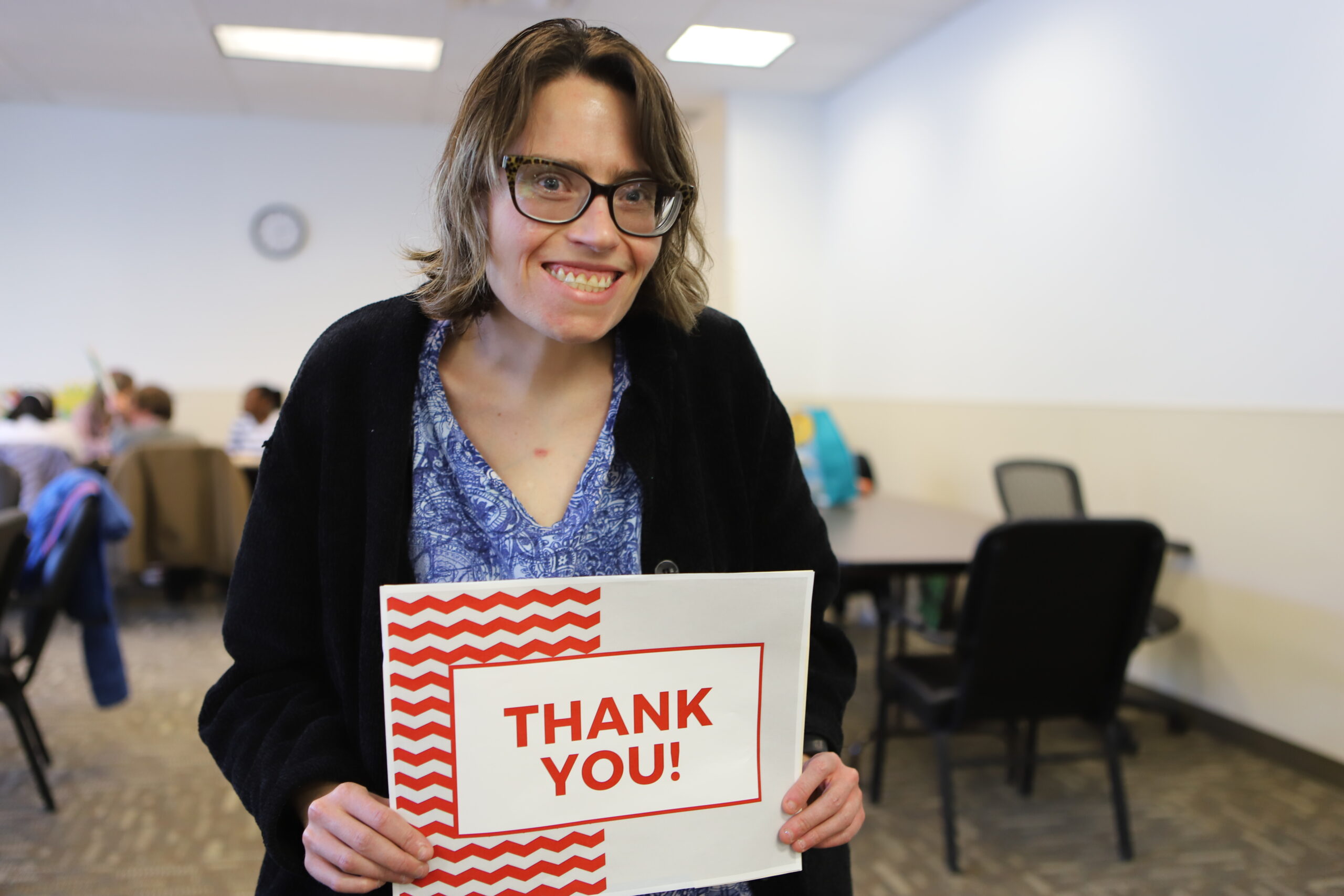 woman holding up sign saying Thank You!