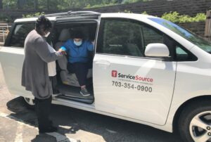 Person lending a hand for someone stepping out of van