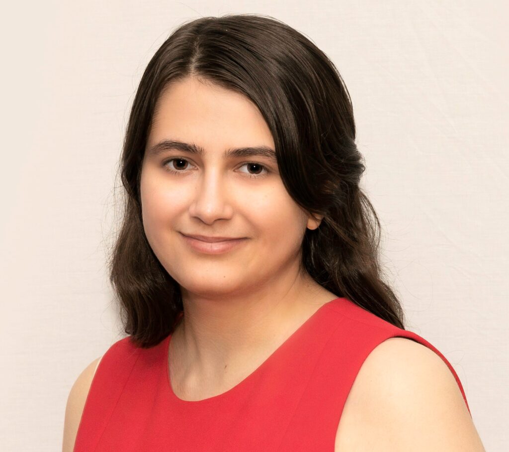 headshot of woman in red dress