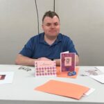 person posing for camera in front of handmade cards