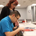 two people looking at red gift bag