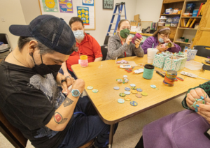 People sitting around table engaging in different activities