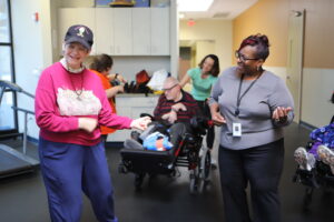 Two people playing "air guitar" smiling