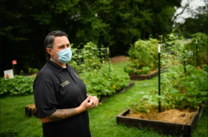 Person with mask outside in garden