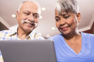 Two people looking at screen of computer