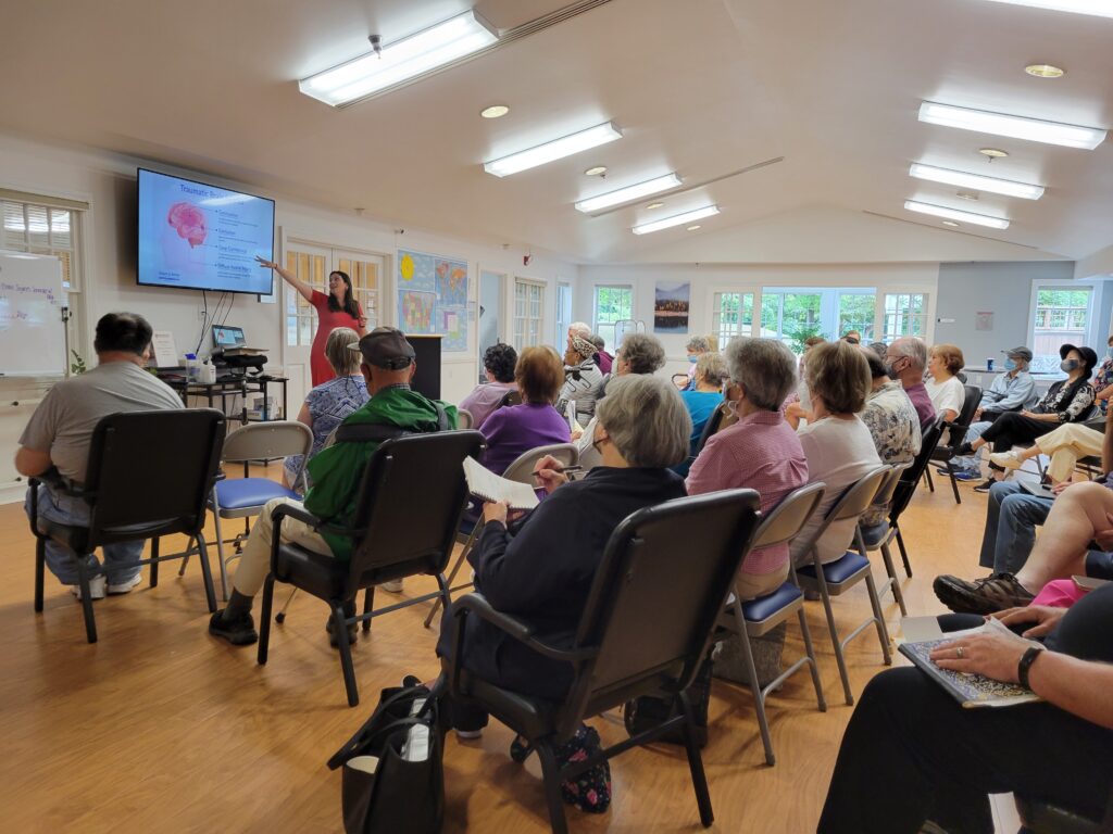 People sitting in a conference for the brain injury topic